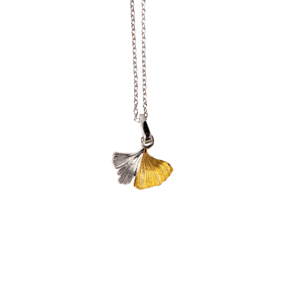 Necklace with a silver and gold leaf pendant on a white background