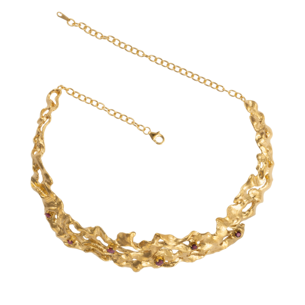 A gold-plated choker necklace with deep red cubic zirconia garnet gemstones.