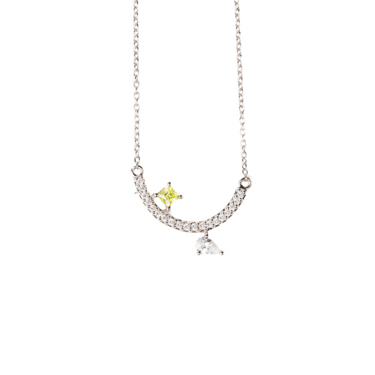 Necklace with a yellow and clear pendant on a white background