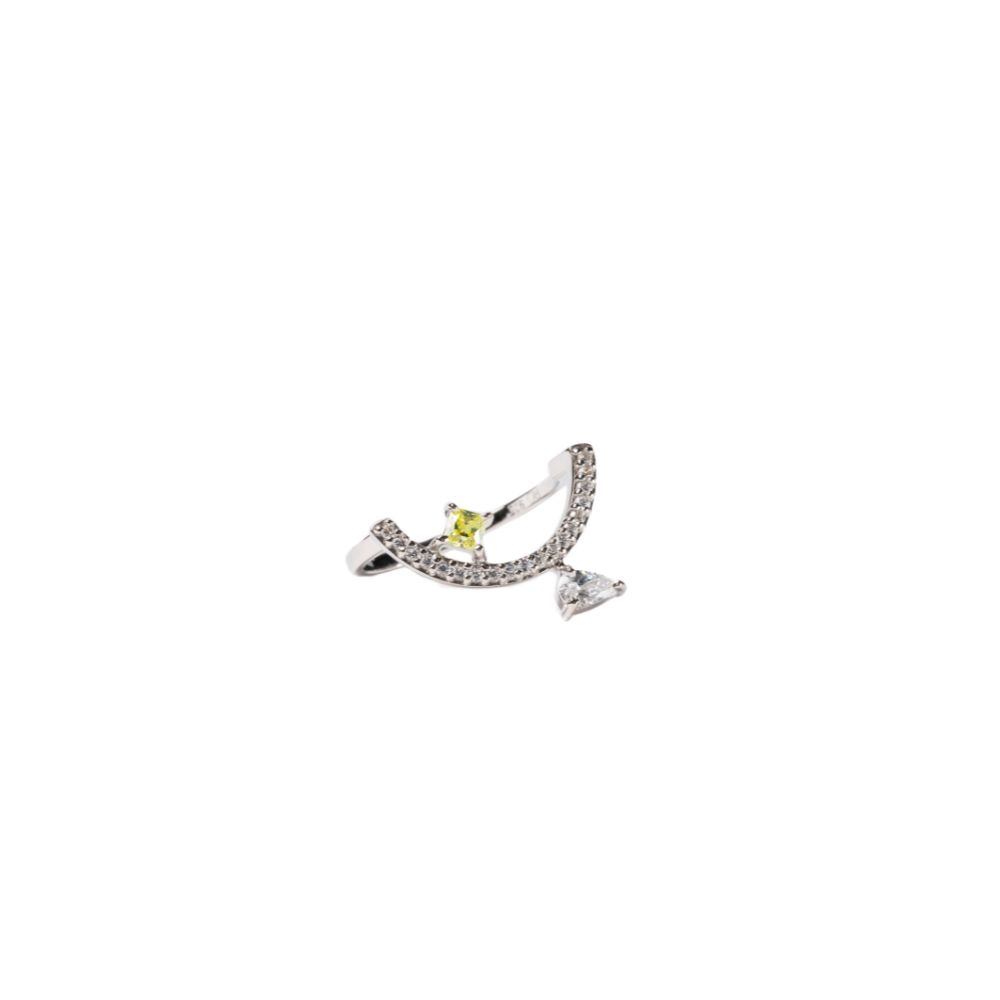 Silver ring with a yellow gemstone and triangle-shaped gem on a white background