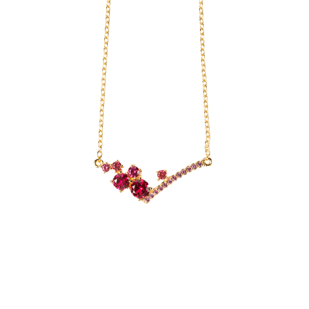 Gold necklace with red gemstones on a white background