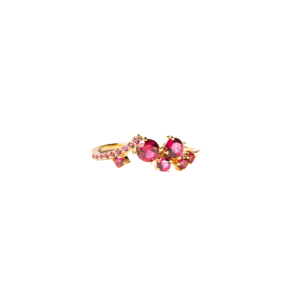 Gold ring with pink gemstones on a white background