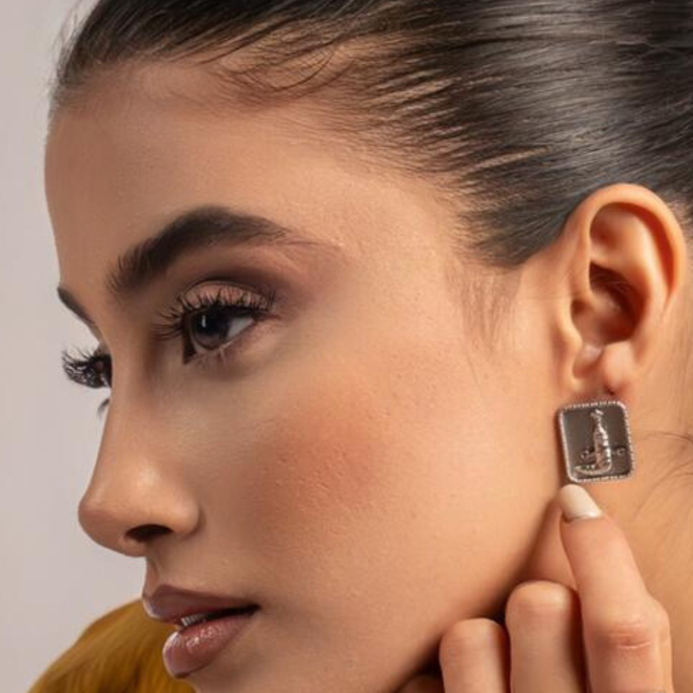 Woman wearing sterling silver Khanjer earrings with Omani khanjar motif design