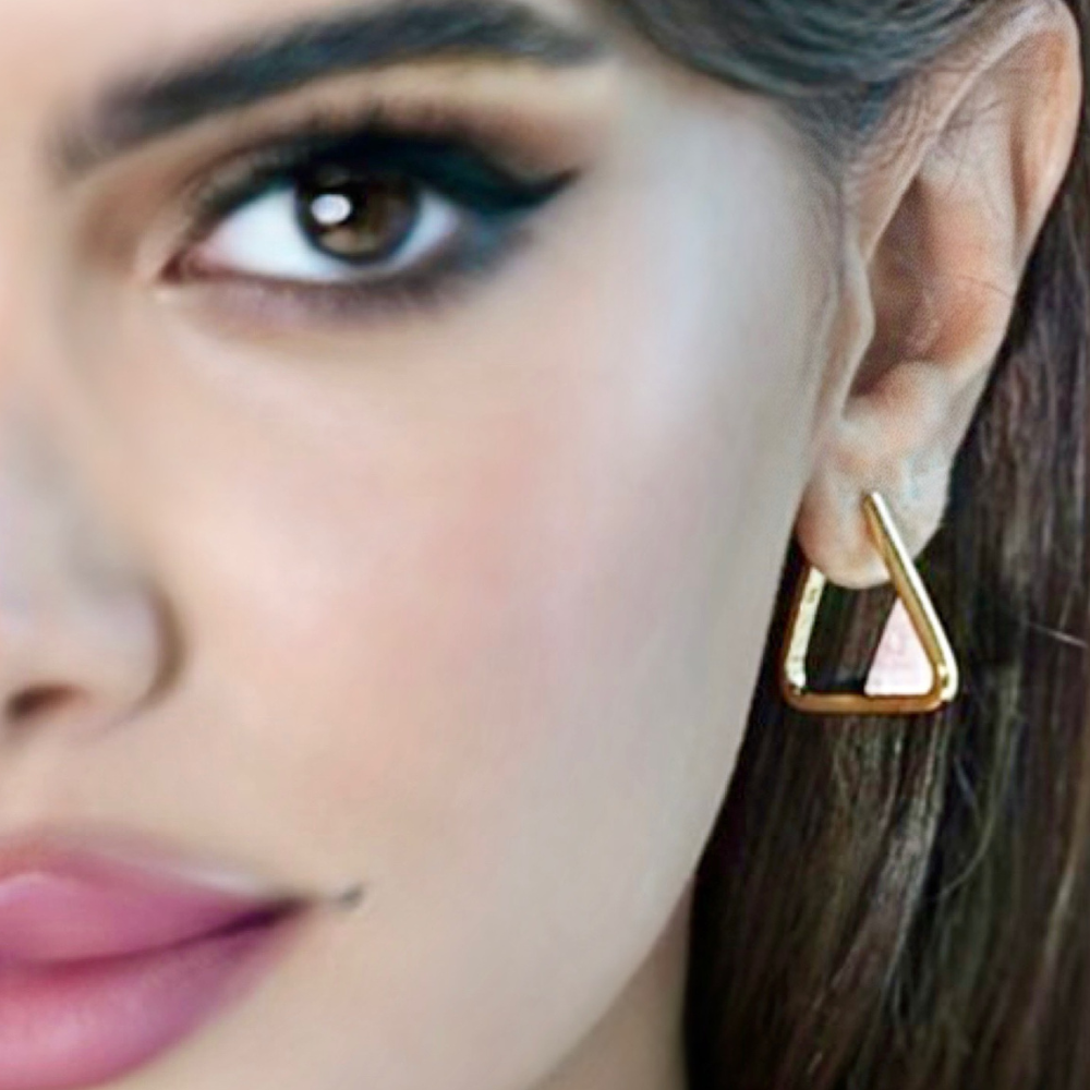 Woman wearing Scarlet gold-plated triangle hoop earrings with coral gemstone
