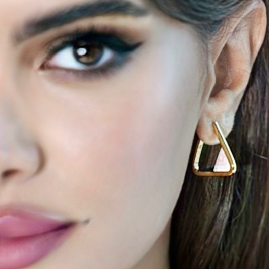 Woman wearing Scarlet gold-plated triangle hoop earrings with coral gemstone