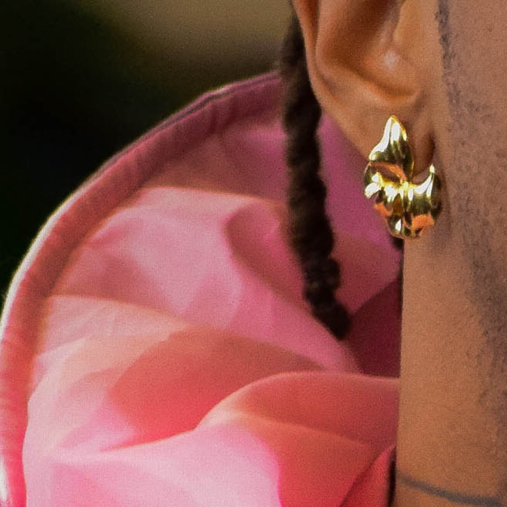 Woman wearing Sophie gold-plated leaf earrings in 925 sterling silver with elegant nature-inspired design