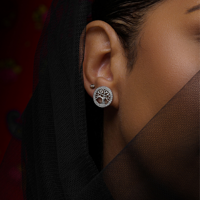 Woman wearing Luban sterling silver earrings with cubic zirconia stones