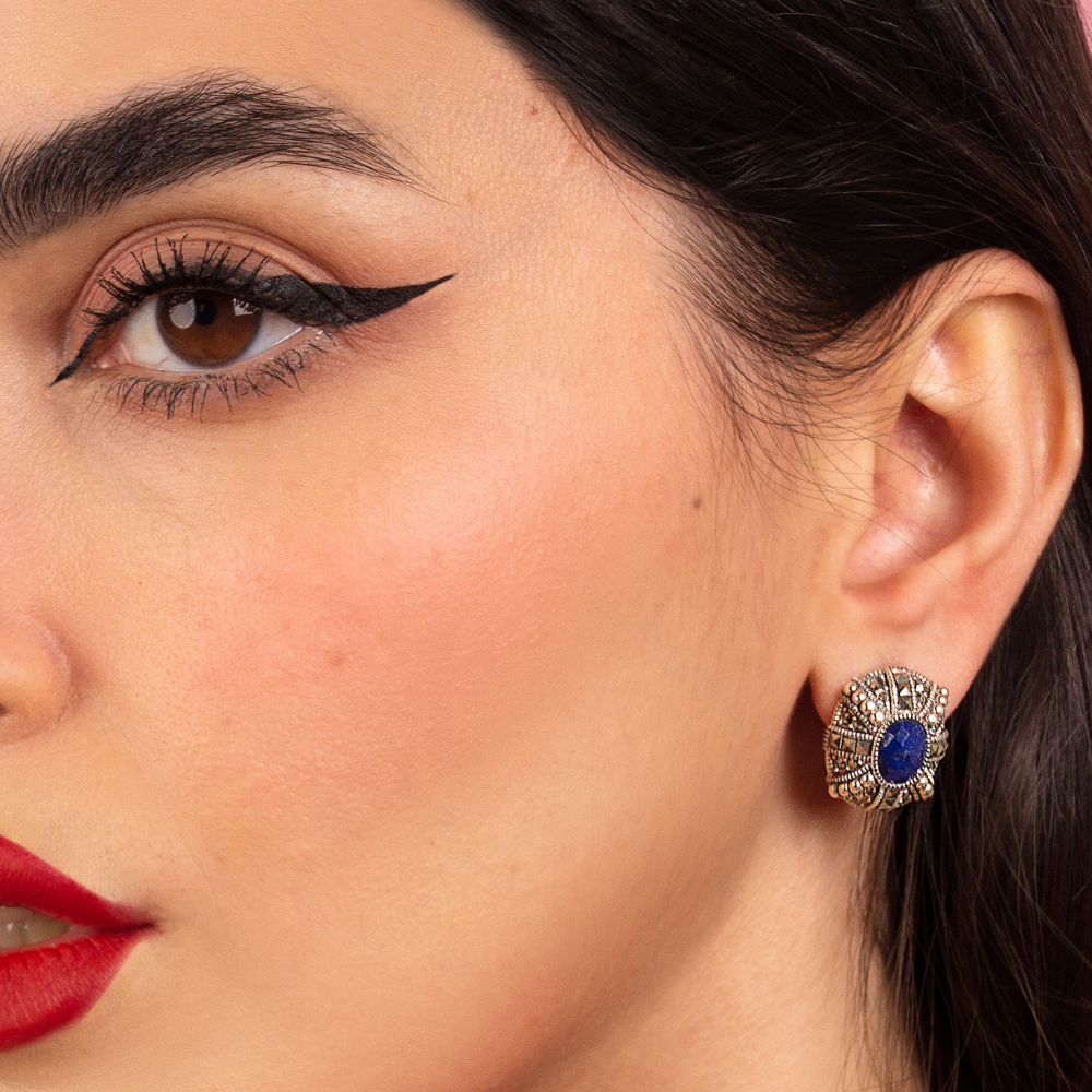 Woman wearing oxidized silver earrings with blue lapis cabochon and marcasite stones