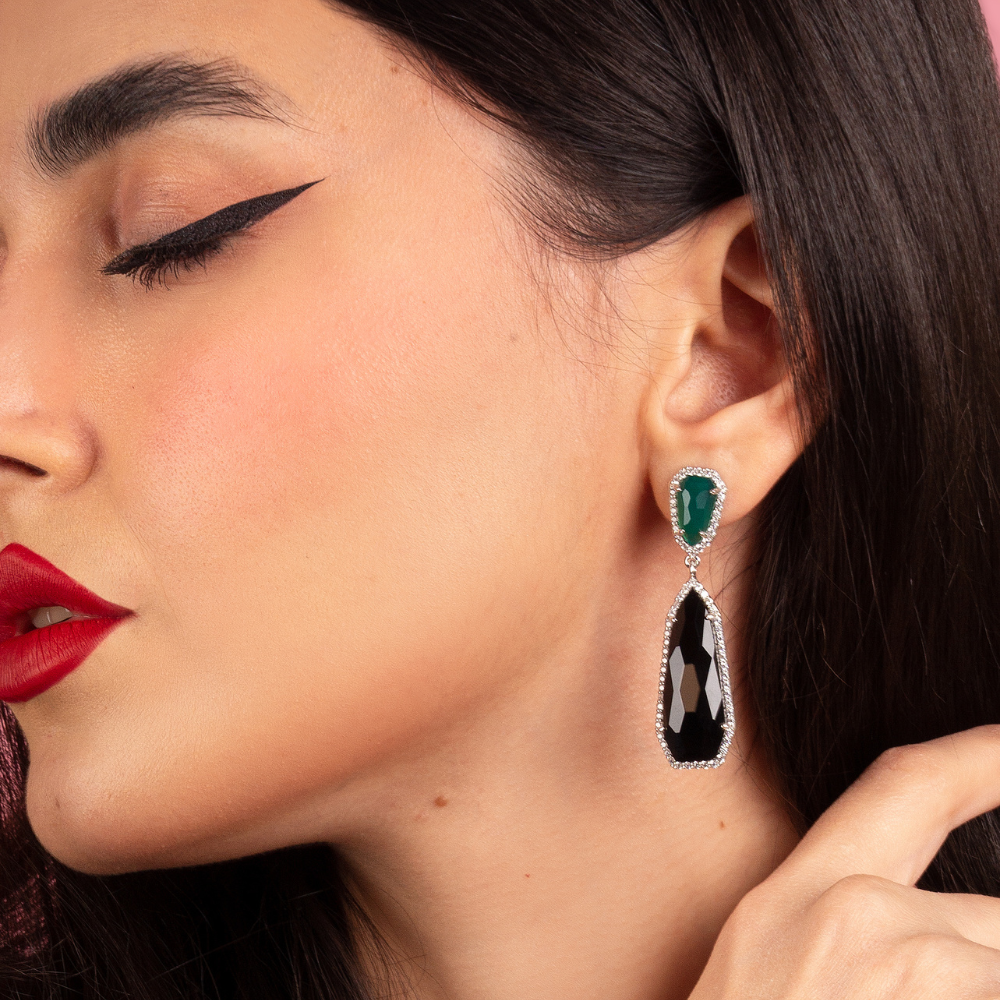 Woman wearing Sasha sterling silver earrings with green agate, black onyx, and white cubic zirconia stones